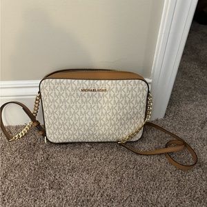 Michael Kors Crossbody Tan and White with MK throughout the bag.